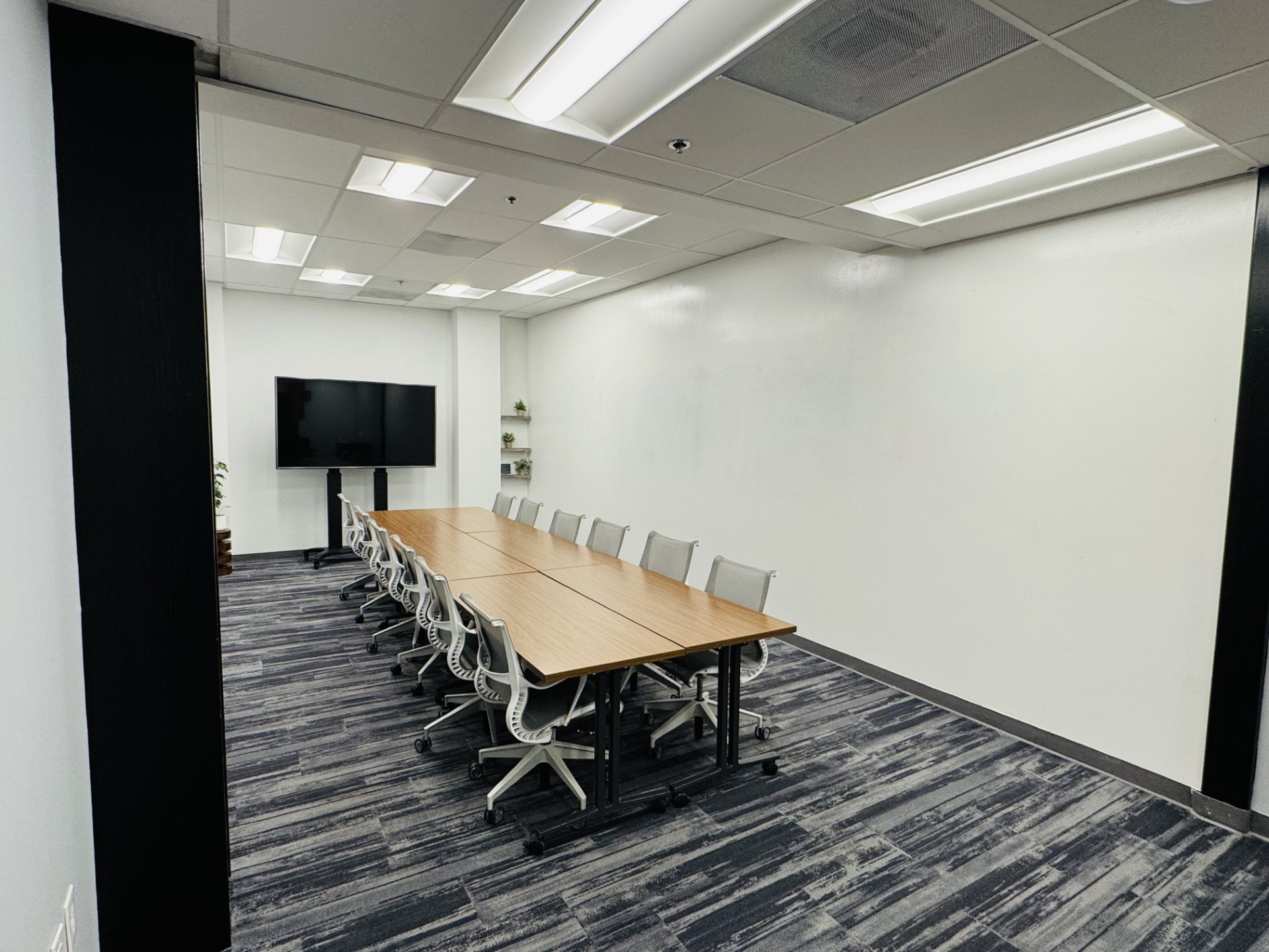 The Town Hall meeting room at Granite City Workspaces, providing a tech-forward setup for collaborative team sessions and strategic offsites
