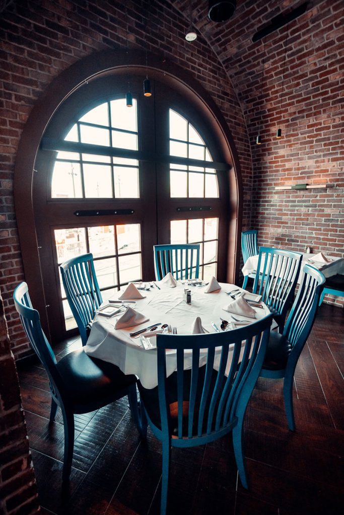 Historic architecture meeting room at Granite City Workspaces, blending brick character with modern display technology for client consultations